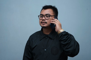 Man with beard talking by mobile phone