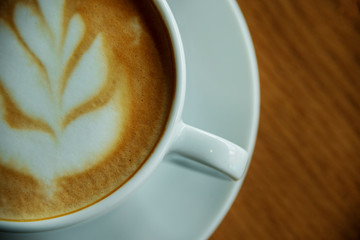 Cup of hot cappucino on the wooden table. Early morning breakfast