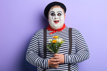 friendly kind mime congratulating all women with Mother's day. holiday concept.isolated blue background, studio shot. lifestyle