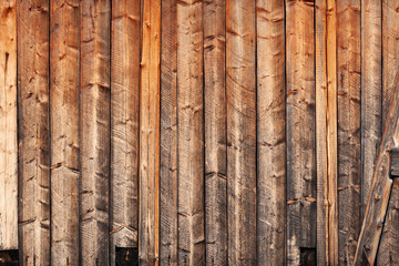 Old shabby worn wooden boards - background, wall of vintage house. Rural texture.