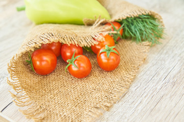 close up of freshly pickled harvest of vegetbles - bell pepper, drill and tomatoes on wooden table. Rustic style. Organic healthy food concept with copy space