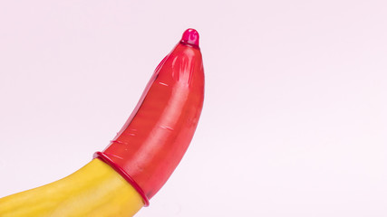 Banana with red condom and copy-space