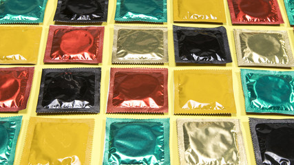 High angle different coloured wrapped condoms