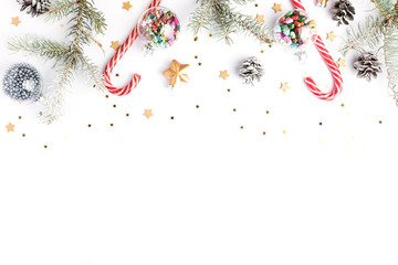 Christmas background with fir tree branches, stars and decor. Top view, flat lay, copy space. Isolated on white