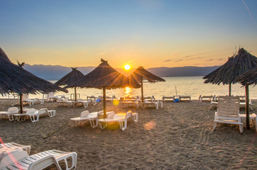 Dojran, Macedonia – Sunrise scene – sunshades on beach