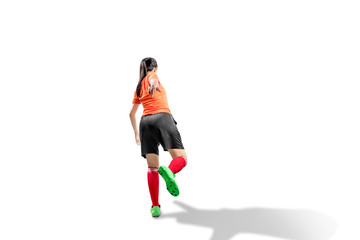 Rear view of Asian football player woman in the pose of kicking the ball
