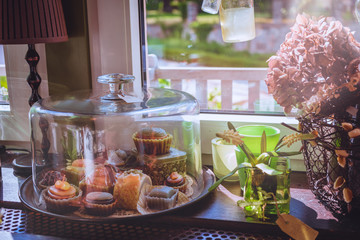 Coffee house vintage decoration with petit fours and macrons