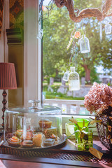 Coffee house vintage decoration with petit fours and macrons