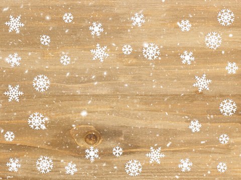 Brown wooden Christmas background with snowflakes. Christmas and New Year concept