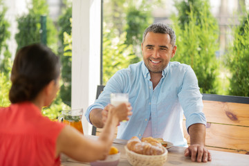 Couple feeling truly relieved enjoying breakfast outside