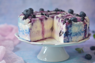 Cold cheesecake with berries on a white plateau