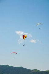 Paraglider flight over the mountains.