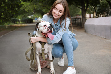 Young woman with cute dog in park