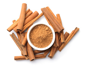 Aromatic cinnamon sticks and powder on white background