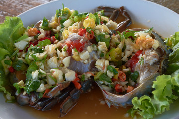 raw mud-crab in fish sauce and Thai recipe spicy sauce topping.