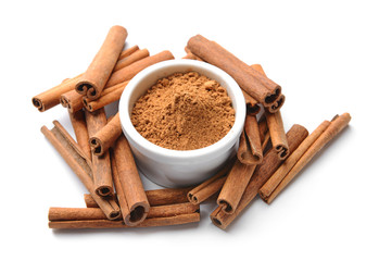 Aromatic cinnamon sticks and powder on white background