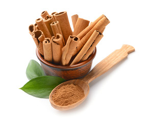 Aromatic cinnamon sticks and powder on white background