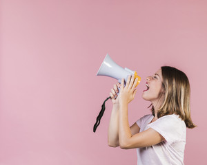 Side view girl screaming on a megaphone