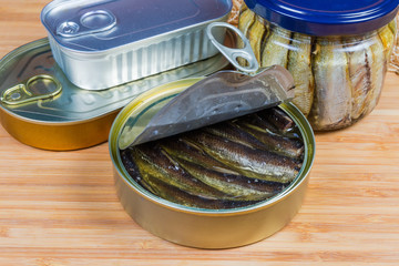 Smoked sprats in the open tin can close-up