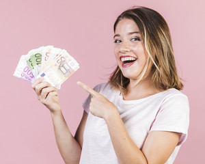 Medium shot happy girl holding money