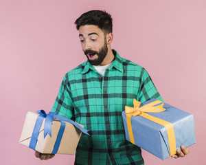 Medium shot delighted guy holding gifts