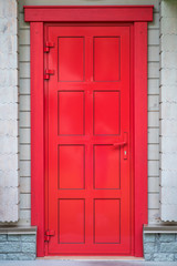 bright red door in a wooden house