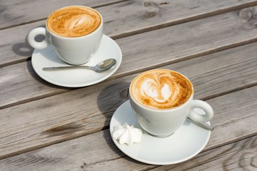 Two cups of cappuchino with cinnamon