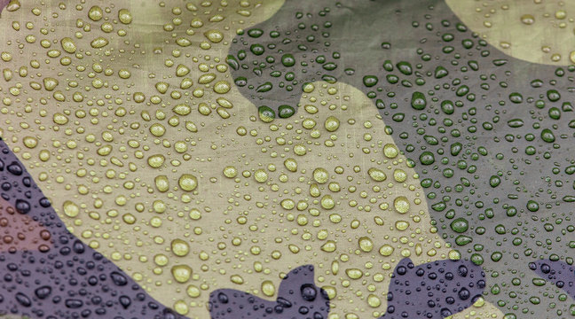 Raindrops on khaki color tent as abstract background