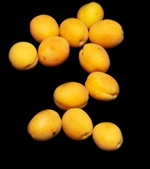 Ripe apricot on a black background