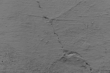Texture of a concrete wall with cracks and scratches which can be used as a background