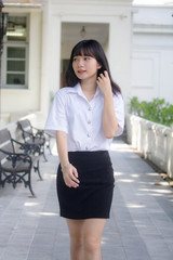 Obraz premium Portrait of thai adult student university uniform beautiful girl relax and smile