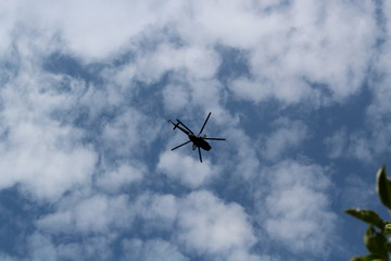 silhouette of big military helicopter in the sky