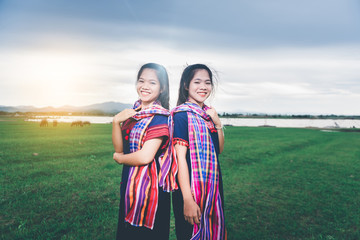 Fototapeta premium Portrait of beautiful Asian girl with local dress, standing in the mist of fieldt at countryside of Thailand