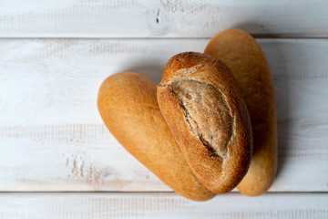 rye and wheat baguettes on white wooden table