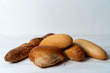 rye and wheat baguettes on white wooden table