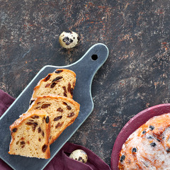 Easter Bread (Osterbrot in German). Top view of traditional fruty bread on dark table with fresh...