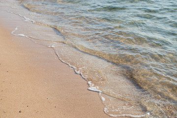 Sea Beach and Soft wave of blue ocean. Summer vacation and travel concept. Copy space