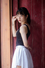 Portrait of thai adult beautiful girl black shirt white skirt relax time