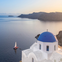 Sunset over local church in Oia, Santorini, Greece