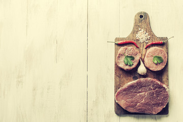 Culinary background with raw beef steaks