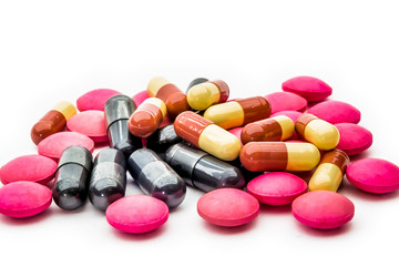 Close up vitamins C and supplements capsules on white background.