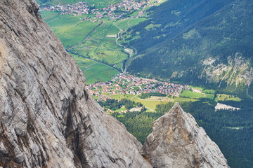 View from the top of a mountain in the Alps to a small village in the valley