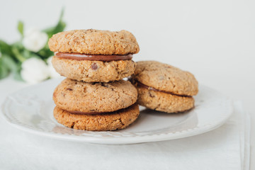 Delicious crumbly sandwich cookies Baci di Dama or Lady kisses with chocolate filling