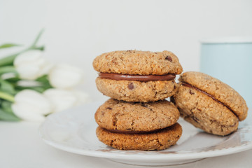 Delicious crumbly sandwich cookies Baci di Dama or Lady kisses with chocolate filling