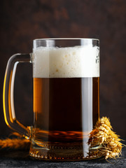 Close-up of a mug of light wheat beer on a dark background