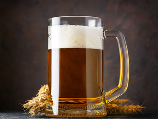 Close-up of a mug of light wheat beer on a dark background