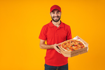 Photo of happy delivery man in red uniform smiling and holding pizza box