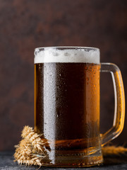 Close-up of a mug of light wheat beer on a dark background