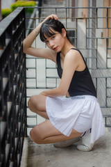 Portrait of thai adult beautiful girl black shirt white skirt relax time