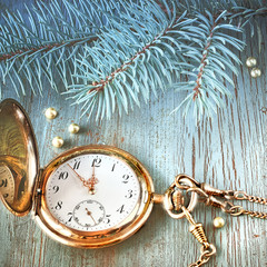 Vintage watch showing five to twelve on gray rustic background w